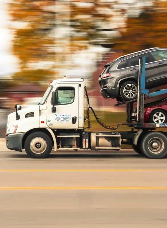 Car carrier truck transporting vehicles on the road