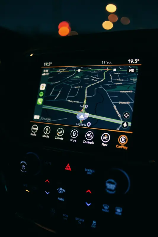 Car dashboard screen showing a GPS navigation map at night