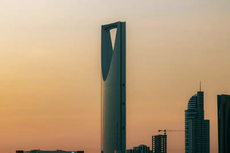Kingdom Centre tower against an orange dusk sky in Riyadh