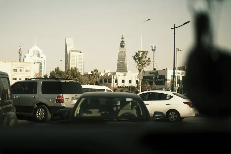 Riyadh traffic seen through a car windscreen, Al Faisaliah tower ahead